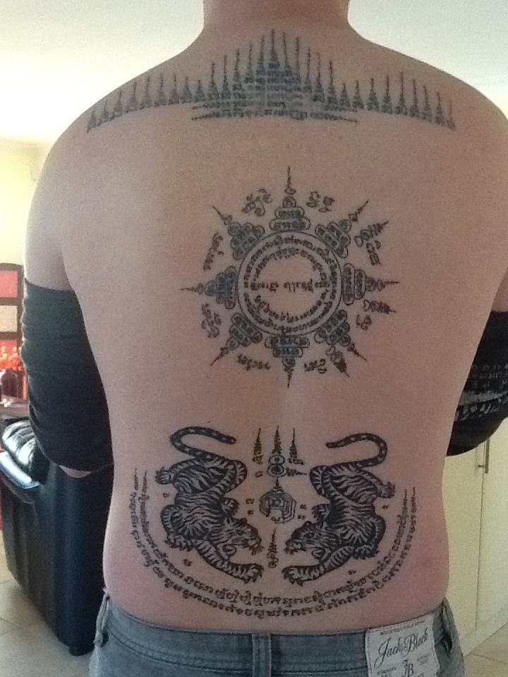 In (Burmese cabalistic square) — sak yant performed in thailand by ajarn nakhon pathom, bottom tattoo by Jirst tattoo pattaya and middle tattoo apple ink