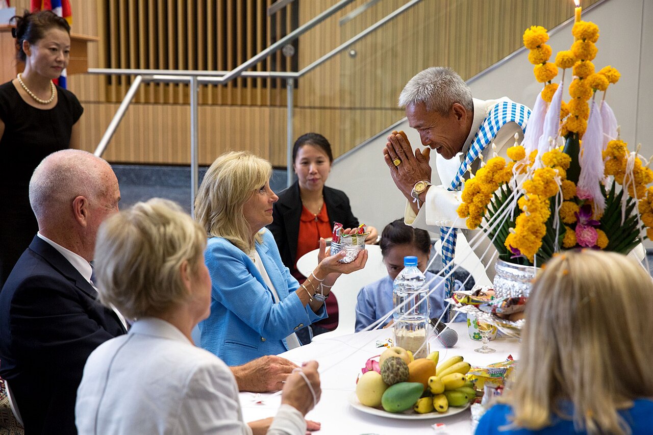Sai sin (blessed cotton thread) — Dr. Jill Biden and U.S. Ambassador to Laos Daniel Clune take part in a Baci ceremony at the U.S. Embassy in Vientiane, L