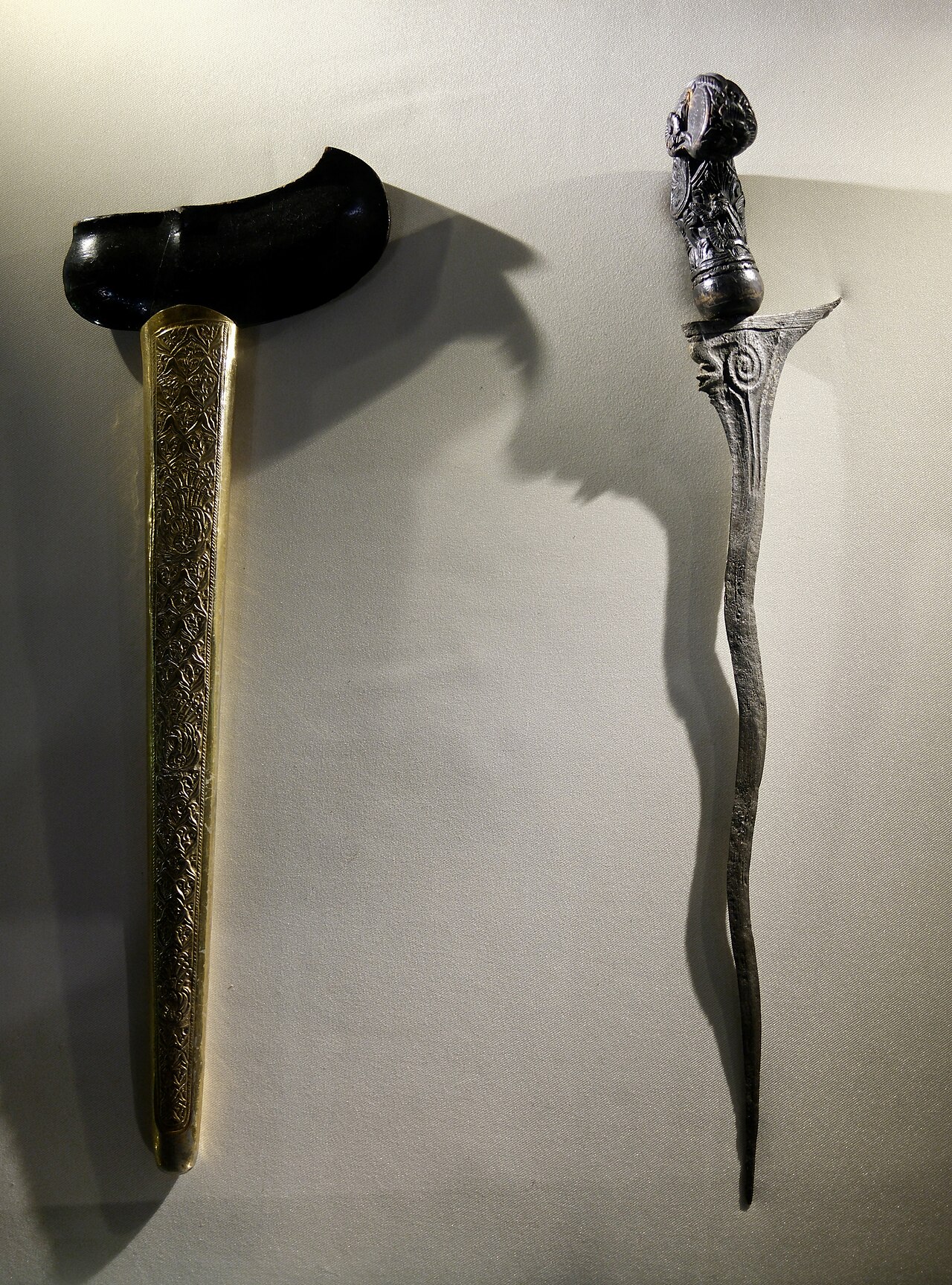 Keris / kris (the heirloom dagger) — The blade of this Javanese Keris has five bends (luk) and is "beras tumpah" damascened (pamor). The hilt features a coat