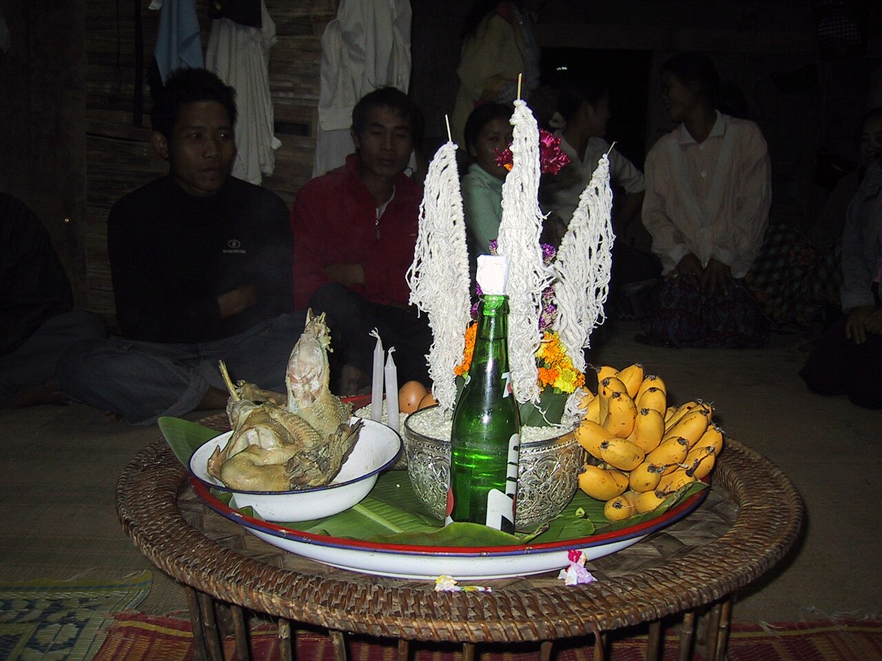 Sai sin (blessed cotton thread) — For a baci ceremony in a small village in Laos near Luang Prabang, coton bracelets to fix on wrists, chicken and rice al