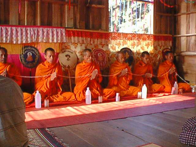 Sai sin (blessed cotton thread) — Monks chanting at a wedding ceremony in Ban Dongphayom, Nakhon Pa Mak, Bang Krathum, Phitsanulok, Thailand