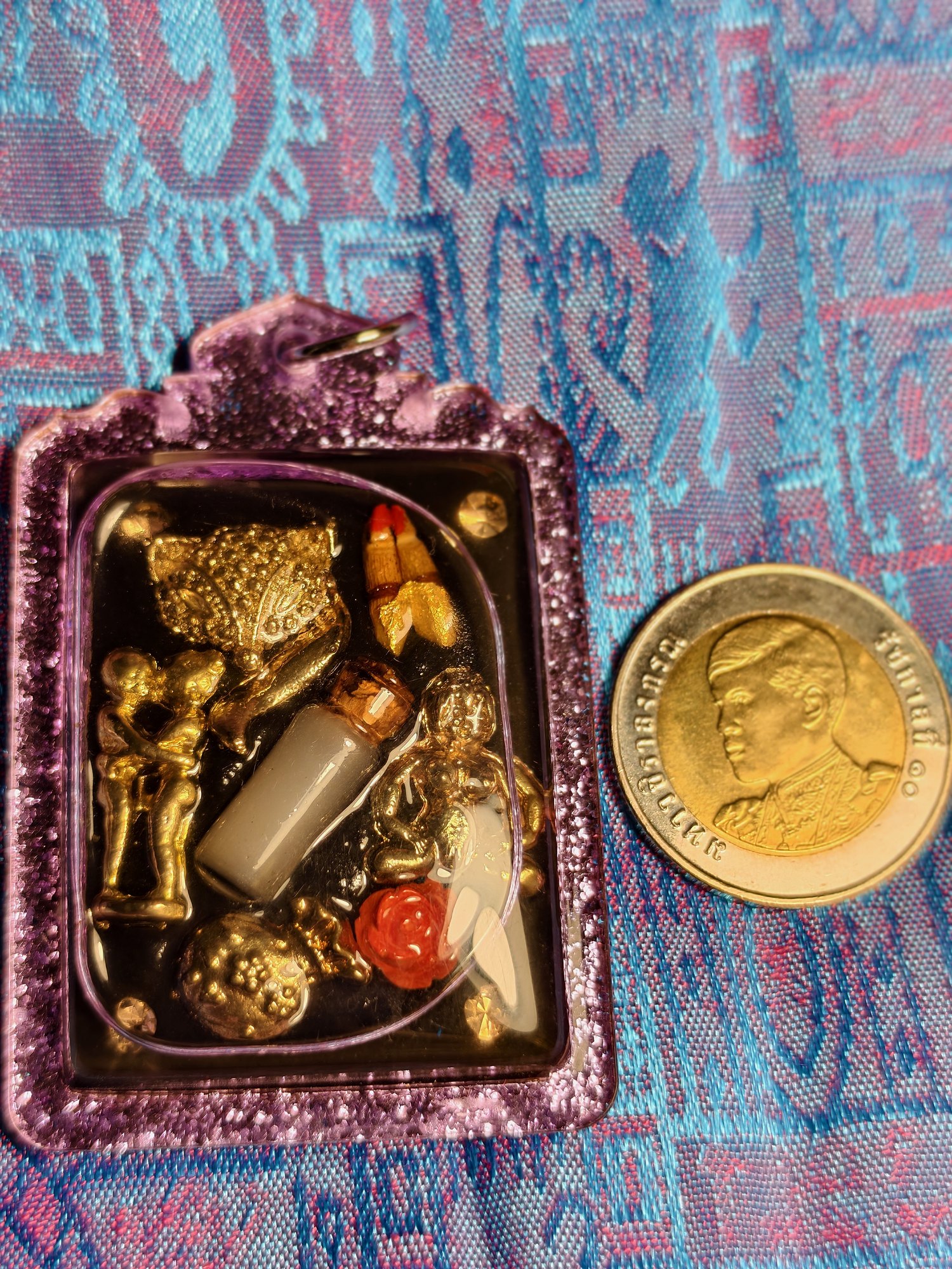 Gambling amulet: small charms set in resin, purple frame, photograph 2