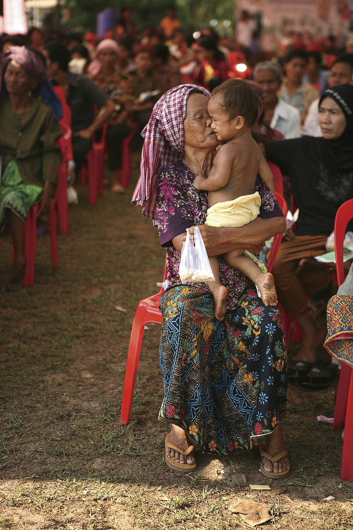 Khmer yantra cloth — A Cambodian woman brings her grandson to see doctors May 10 at the Friendship Clinic in Kampong Chhnang Province during