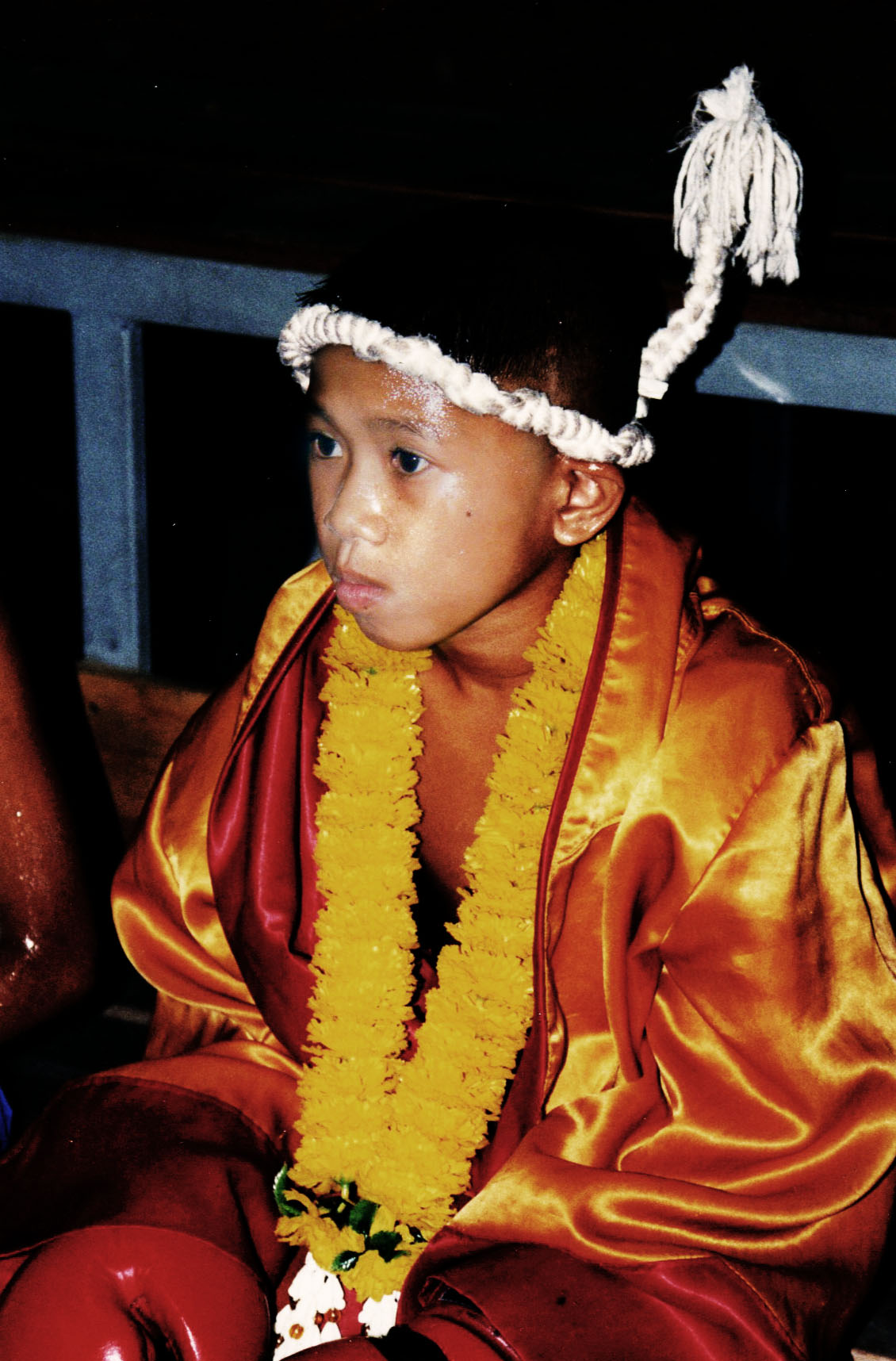Prachiat (yantra head-cloth / armband) — Young Thai boxer waiting for his call to the ring.
