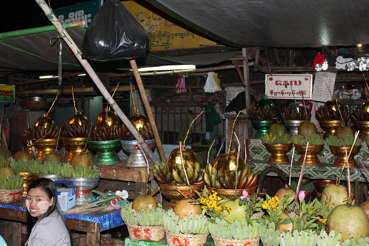 Nat figure (Burmese spirit-deity) — Bowl of bananas and coconuts for offering for Nat (spirit).