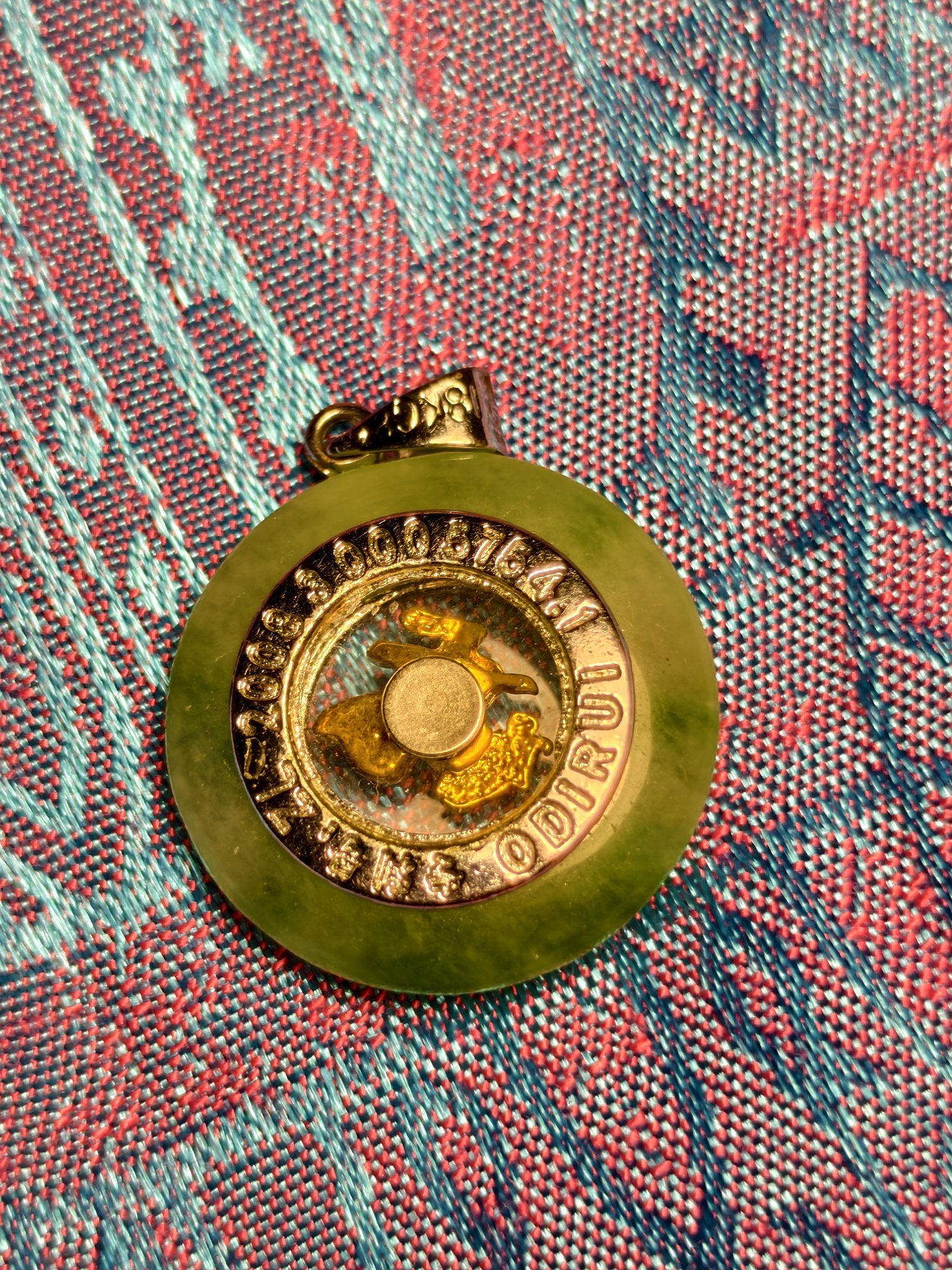 Jade pendant with a lettered rim, photograph 1