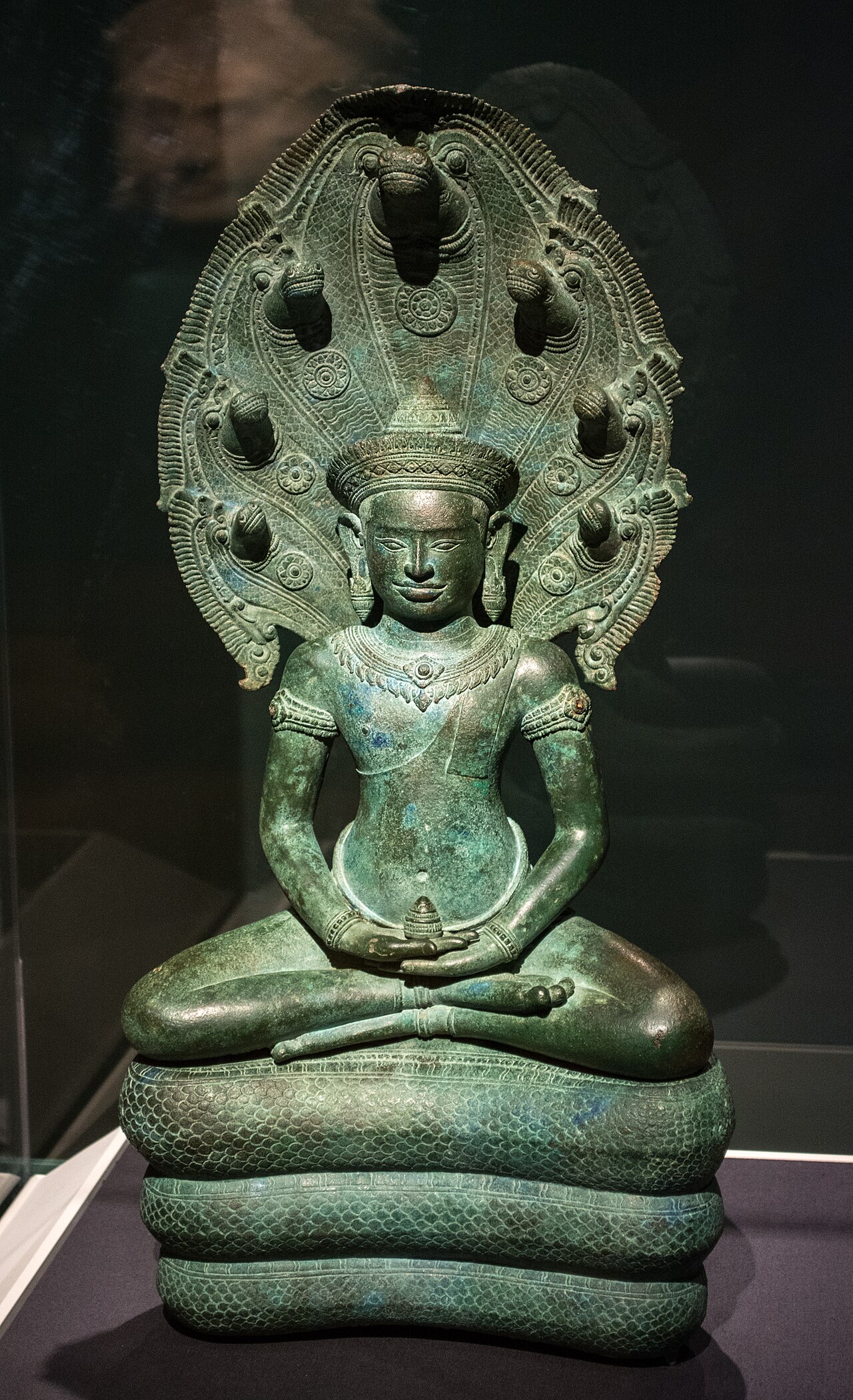 Khmer bronze amulet (Angkorian and post-Angkorian figurines) — Naga-enthroned Buddha.
Bronze, about 1100 AD.
Banteay Chhmar, Cambodia
The Buddha represents the union of compassion and