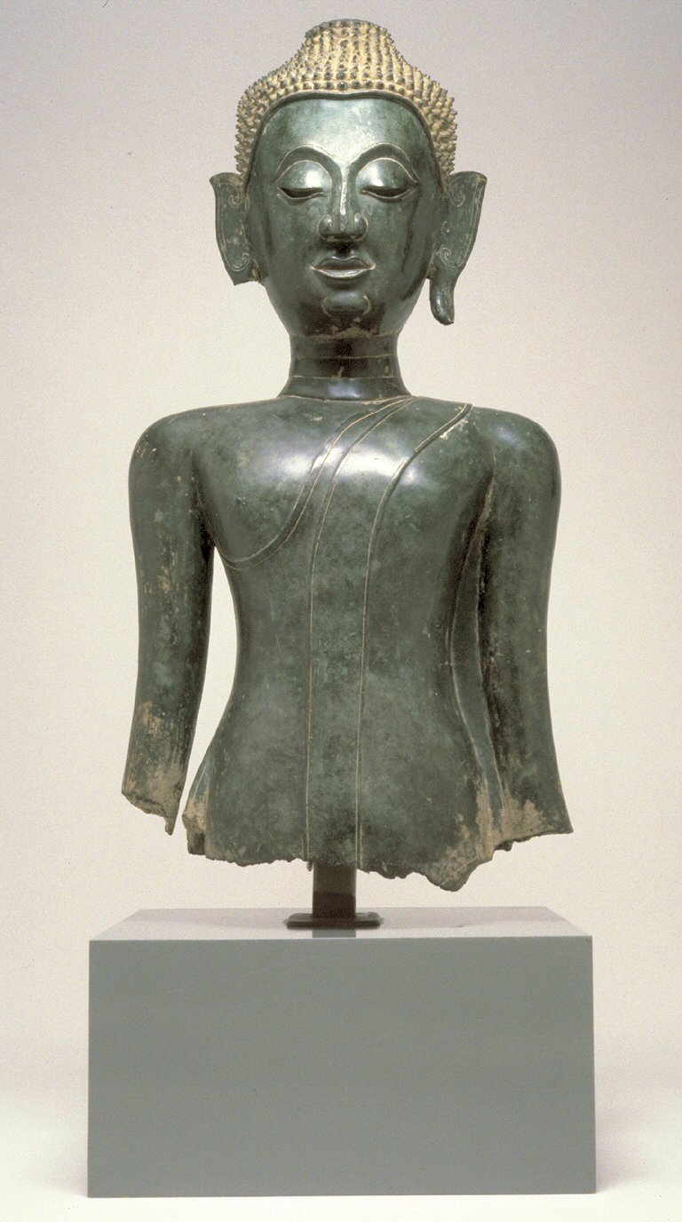 Lao Buddha amulet (Luang Prabang and Vientiane temple issues) — Originally the arms of this large and striking image fell at the side, and the sides of the robe flared outward at the b