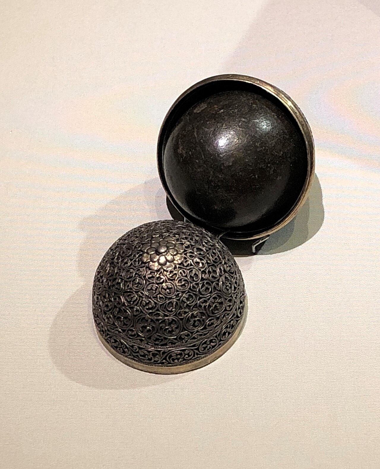 Batu mustika (stones and 'pearls' of inherent power) — Bezoar stone with a silver hodler, from 17th century India. Exhibit in the Asian Civilisations Musuem, Singapore.