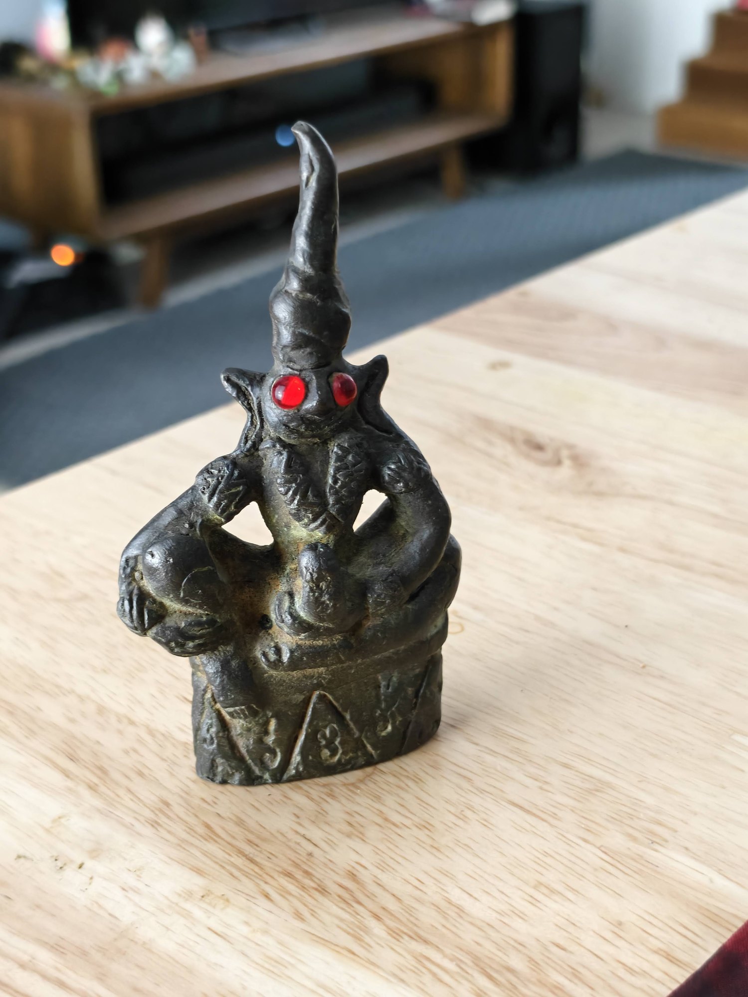Ngang, bronze, red eyes, photograph 1