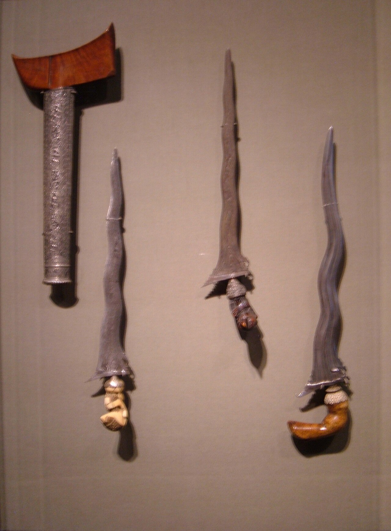 Keris / kris (the heirloom dagger) — Three kris and a scabbard on display at the Asian Art Museum in San Francisco, California.