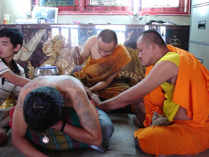 In (Burmese cabalistic square) — Hlwong Pi Nan tattooing Yant at Wat Bang Phra Temple