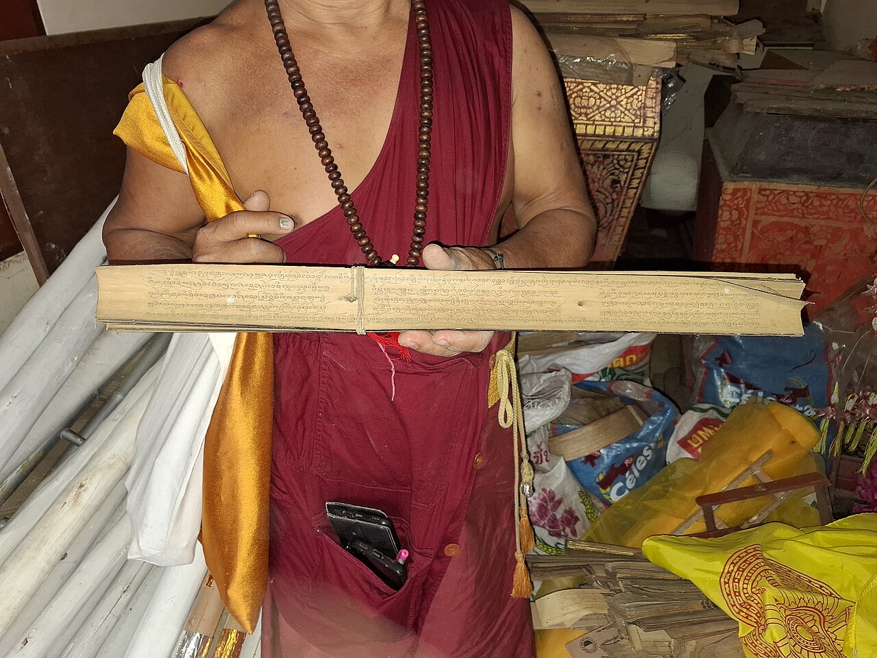 Lanna yantra (Tai Tham script) — Wat Ku Daeng - head monk with a palm leaf manuscript written in the Lanna script
