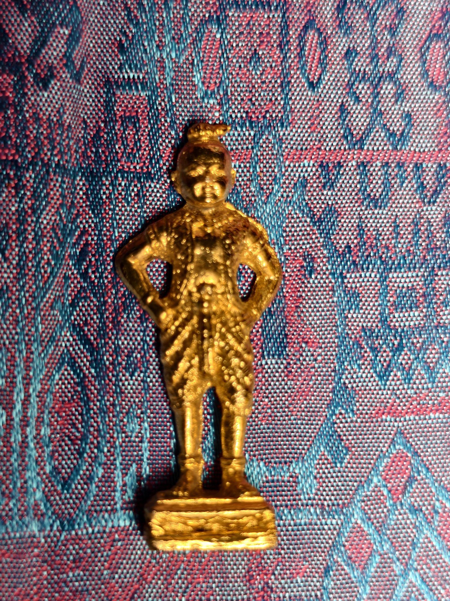 Standing gilt figure, fists on hips, photograph 1