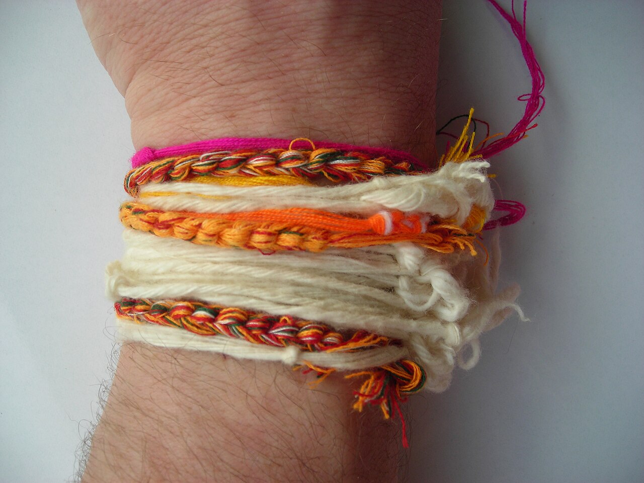 Sai sin (blessed cotton thread) — Textile arm bands (like bracelets) with knots called "Fei phook Ann" in Thai - traditionally given to people wishing the