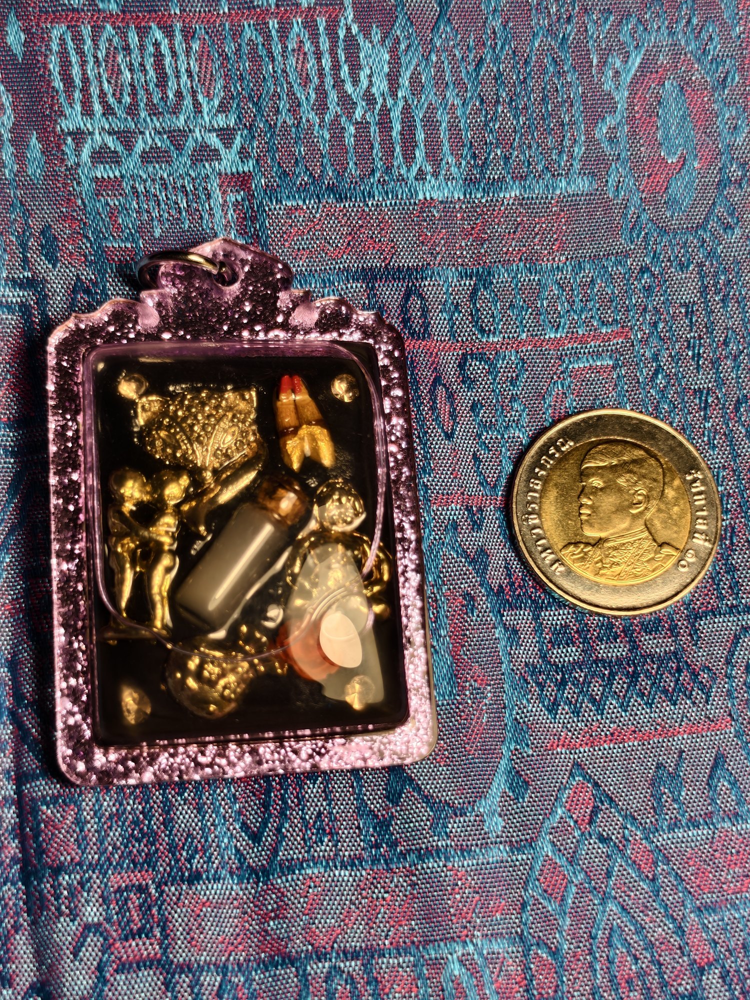 Gambling amulet: small charms set in resin, purple frame, photograph 1