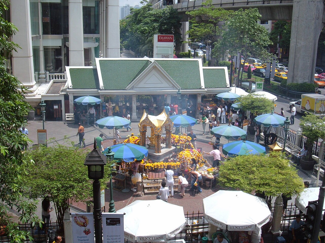 Four-faced Brahma pendant — The Erawan Shrine in Bangkok, Thailand as seen from a pedestrian walkway.